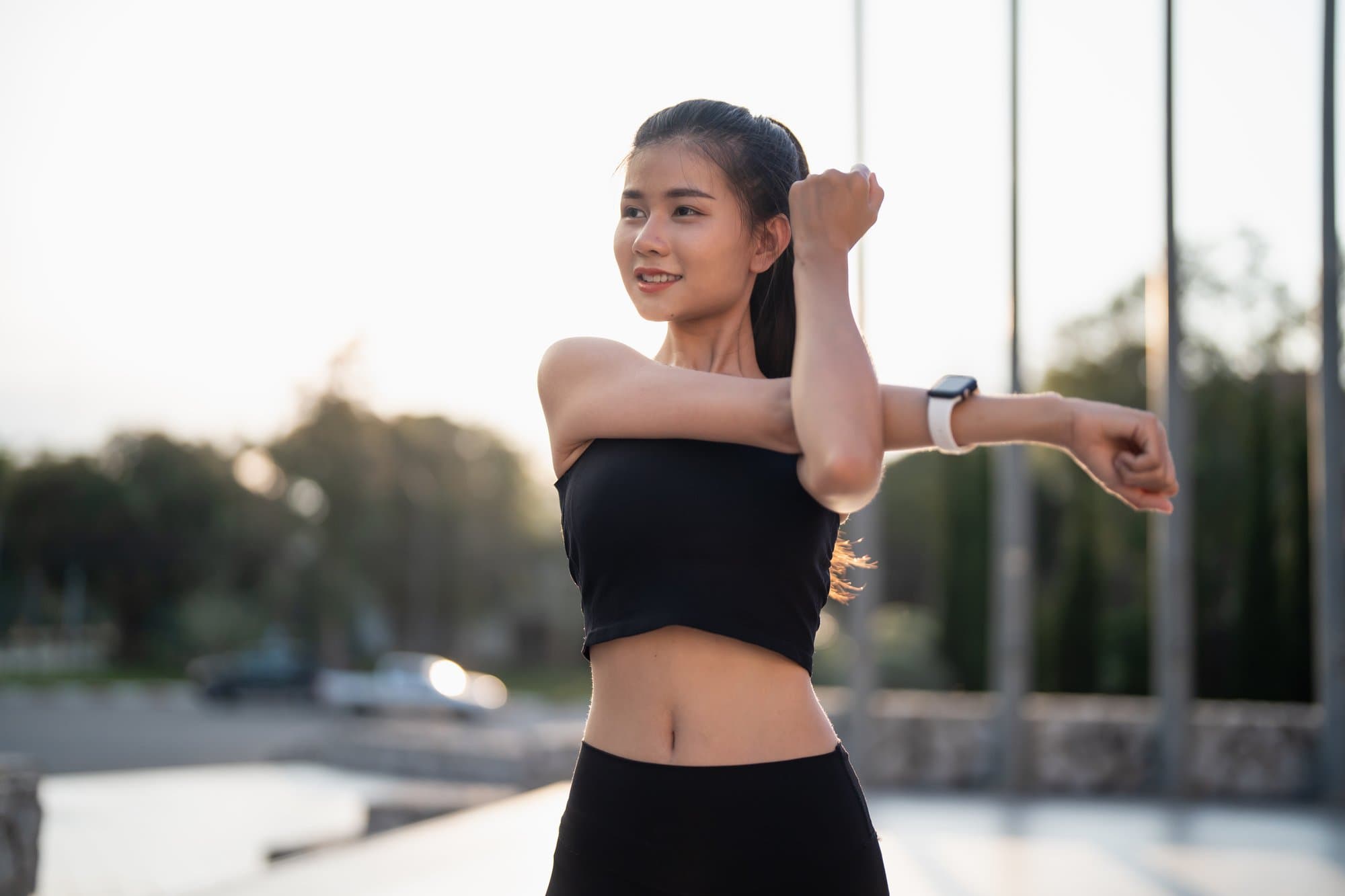 Active woman stretching at sunrise — healthy lifestyle supported by Primaldew daily super greens supplement
